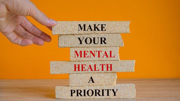Concept words Make your mental health a priority on brick blocks on a beautiful orange background