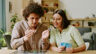 Couple playing modern thematic tabletop game