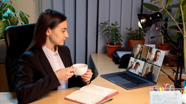 Young woman talking working during videoconference with colleagues at home