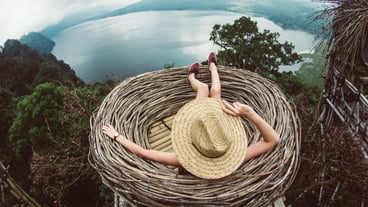 Woman sitting on a hill looking the amazing landscape. Girl travelling Asia