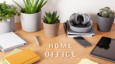Home office text desk with tablet computer smartphone notebook houseplants working space at home
