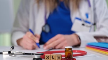 Doctor Writing a Prescription while Using a Stethoscope along with a Medicine Bottle