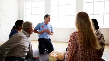 Diverse people taking a CPR first aid training class