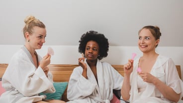 Female friends holding hands at home