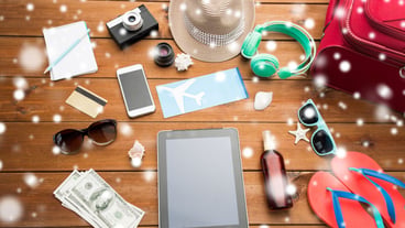 Vacation, winter break, tourism and technology concepts - Tablet PC computers, plane tickets, travel stuff on snow