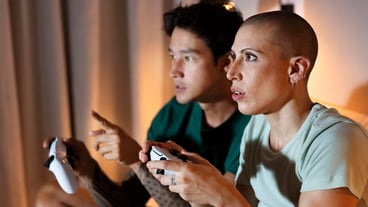 Girlfriend and boyfriend playing video games together at home