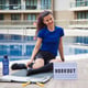 Young Caucasian woman exercising outdoors by the pool. Sport in times of pandemic.