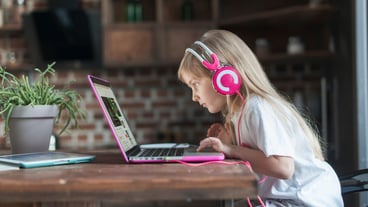 Girl with laptop at table