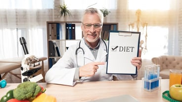 Smile doctor is holding diet sign in clinic room.