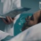 Professional doctor assisting a patient and checking medical records