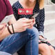 A man who uses social network notification icons on his cell phone
