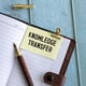 Knowledge transfer text with magnifying glass on blue background