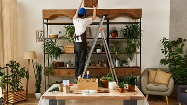 Handsome young man skillfully arranging plants in a bright studio space for a lively atmosphere