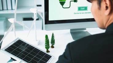 Businessman working in office developing plan on alternative energy Gyre