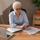 Confident stylish european middle aged senior woman using smartphone at workplace stylish older matu
