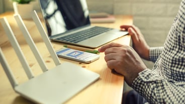 Man's hand using cell phone with email application