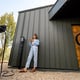 Woman waits for electric car to be charged