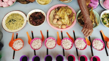 Cropped hand of woman having food at table