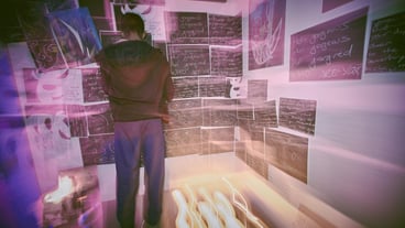 Rear view shot of unknown man with mental disorder standing alone at night feeling paranoid Mixed race man mentally ill feeling depressed and arranging pictures in bedroom OCD male out of control