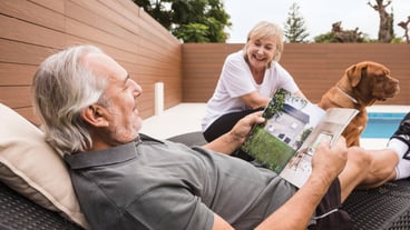 Senior couple with dog in garden