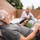 Senior couple with dog in garden