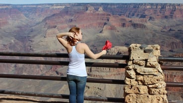 Woman standing on rock against mountain
