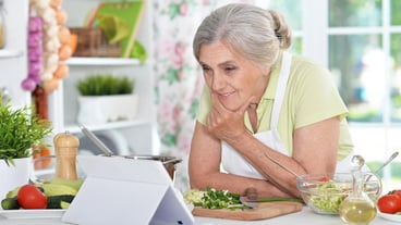 Woman reading recipe on laptop