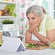Woman reading recipe on laptop