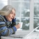 Senior woman working with laptop at home