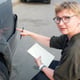 Middle-aged insurance agent performs a pre-insurance inspection of the car