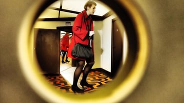 Full length of woman seen through keyhole
