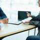 Guarantee Insurance Sign a contract couple a smiling couple is signing a contract to invest in real estate with the Mortgage officer with the bank