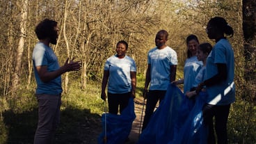 Team of activists picking up plastic waste to recycle and collect rubbish