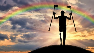 Happy a disabled person with a prosthetic leg holding crutches on a background of clouds and rainbows