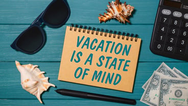Craft notebook with the words Lets Travel Again, glasses, money, calculator and seashells