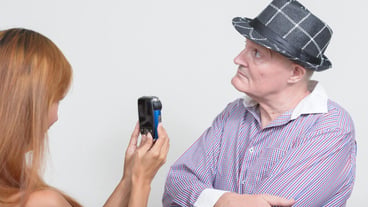 Midsection of woman photographing with mobile phone