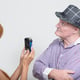 Midsection of woman photographing with mobile phone