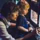 Father and son look at the fish in the aquarium in oceanarium.