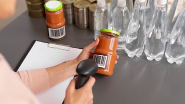 Volunteer scanning food donations for charity