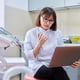 Online consultation doctor help in clinic using laptop Female dentist talking looking in laptop in dental office Video conference videocall service dentistry medicine technology concept
