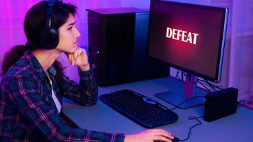 Young Woman Wearing Headphones Disappointed After Losing Video Game