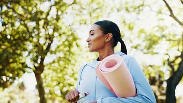 Woman park and yoga mat for fitness with water bottle health and hydration for wellness exercise and fresh air Physical activity equipment and drink with female yogi in nature for self care
