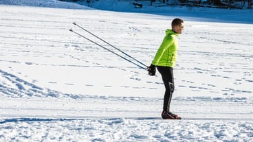 A male skier practicing cross country skiing as a recreational activity