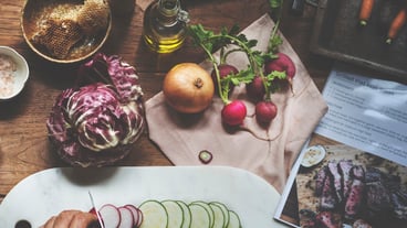 Hands using knife chopping a zucchini