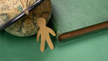 Paper man on globe for business economics, environmental or ecological concept