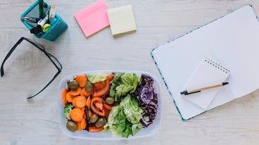 Box with salad on office table