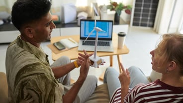 Business couple arguing about wind turbine