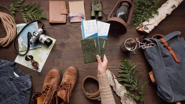 Above the view of the woman with passport and plane ticket on the table