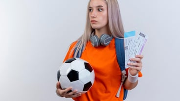 Impressed young caucasian sporty girl with headphones around neck wearing backpack headband