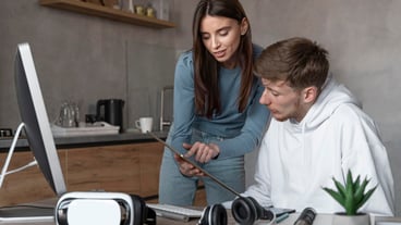 Man and woman looking at tablet together at work